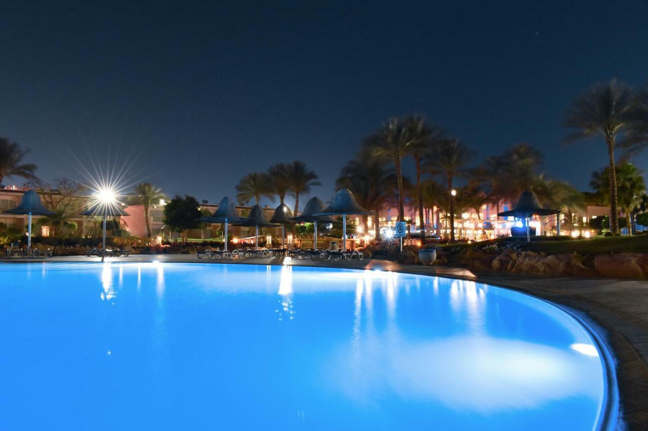 Parrotel Beach Resort Sharm el-Sheikh Exterior photo Night view of the pool at the Hilton Sharm El Sheikh
