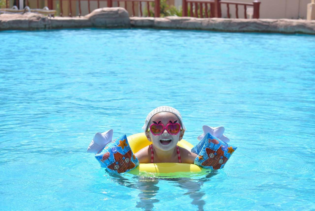 Parrotel Beach Resort Sharm el-Sheikh Exterior photo A child wearing armbands